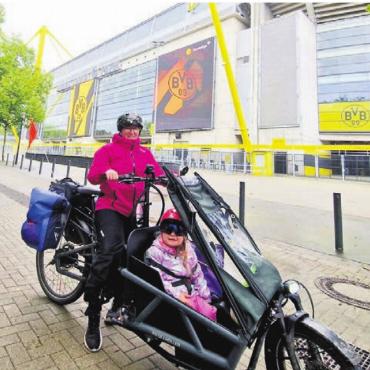 Mit Regen umso spezieller - Am Ziel: Nadin und Nora Leuthold mit ihrem Lastenrad vor dem Signal-Iduna-Park in Dortmund – dem Ziel ihrer Veloreise.