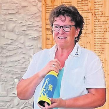 Die Krone geht nach Baden - Milly Stöckli, Präsidentin vom Ortsbürgerverband Aargau, präsentiert die Siegerflasche.