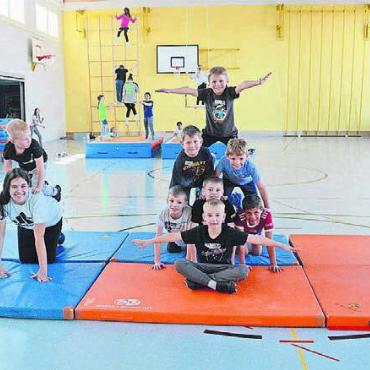 Keine Zeit für Langeweile - In der Turnhalle sind gleich zwei Gruppen am Trainieren: vorne die Akrobaten, hinten die Trapezkünstler. In den ersten zwei Tagen haben sie schon viel gelernt.