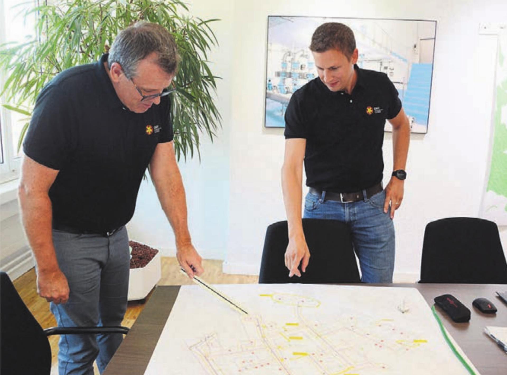 Geschäftsführer Martin Hössli (links) und Projektleiter Jonas Moos mit den Plänen des Verteilnetzes, das immer mehr konkretisiert wird. Bilder: chh