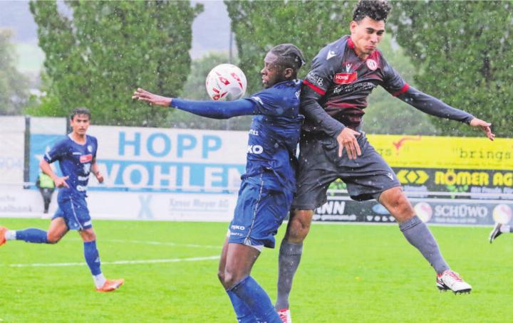 Nathan Kisisa (links) in der Regenschlacht gegen Dietikon. Er trifft zwar zum 1:0, verpasst aber auch einige Chancen. Bild: Josip Lasic