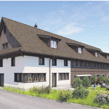 Die Mauer neben der Baugrube - Die Visualisierung zeigt, wie das Reiheneinfamilienhaus dereinst aussehen wird.